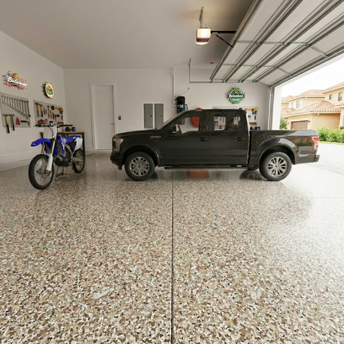 Garage with a black truck and dirt bike on a speckled epoxy floor